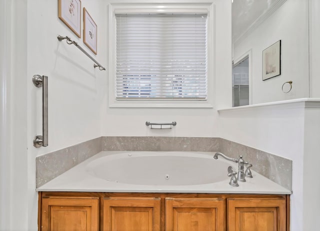 bathroom with a bath and ornamental molding