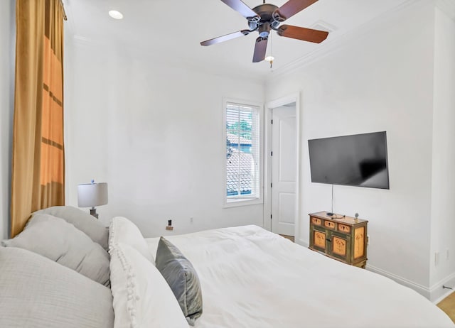 bedroom with ceiling fan and crown molding