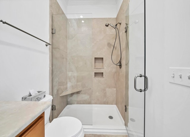 bathroom with walk in shower, toilet, ornamental molding, and vanity