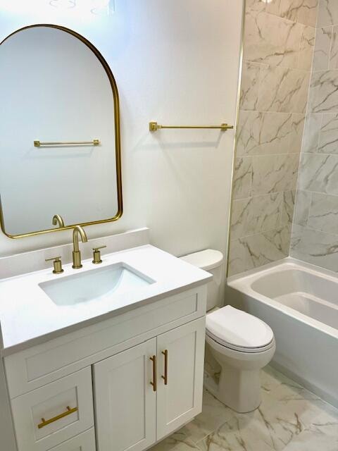 full bathroom with vanity, toilet, and tiled shower / bath combo