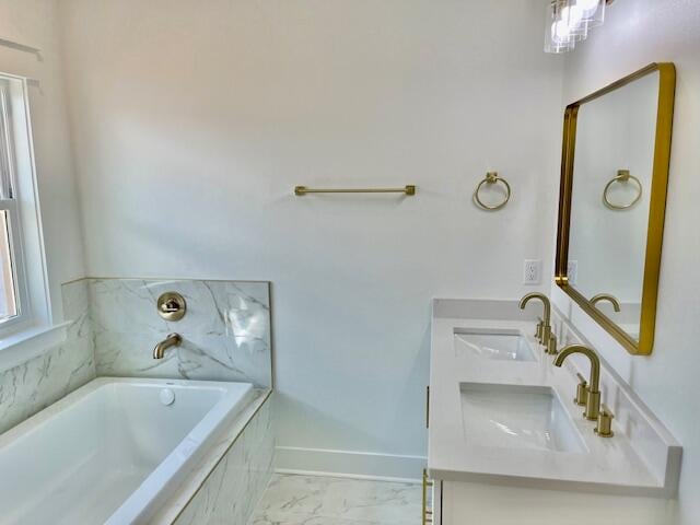 bathroom with vanity and tiled tub