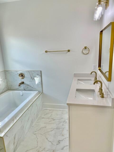 bathroom with vanity and tiled bath