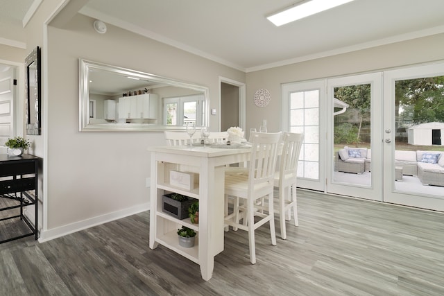 dining area featuring dark hardwood / wood-style floors, ornamental molding, and french doors