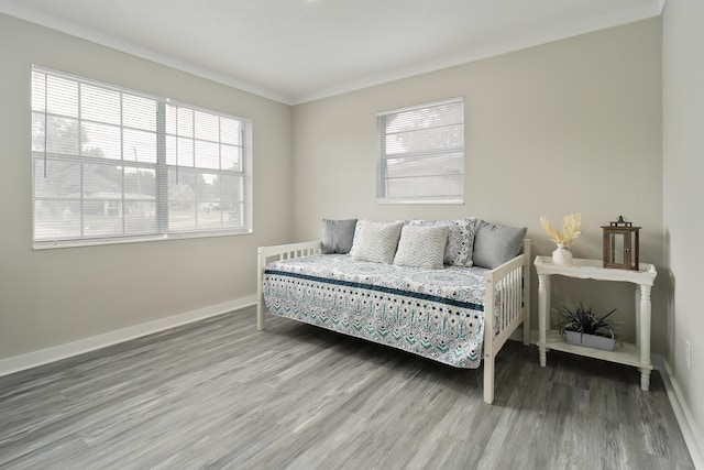 bedroom featuring wood-type flooring and ornamental molding