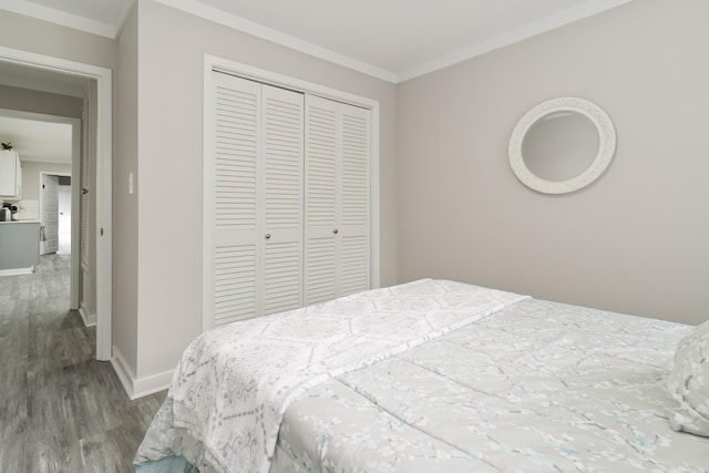 bedroom featuring crown molding, a closet, and wood-type flooring