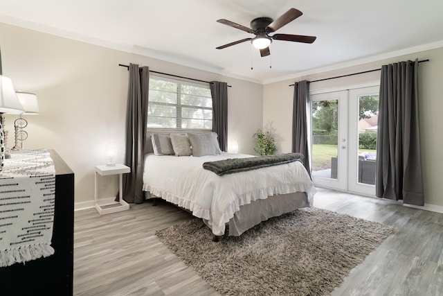 bedroom with french doors, access to exterior, ornamental molding, ceiling fan, and light wood-type flooring