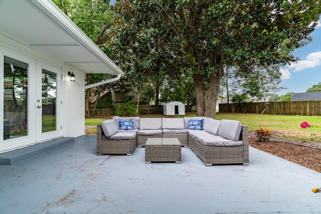 view of patio / terrace featuring outdoor lounge area, a storage shed, and french doors