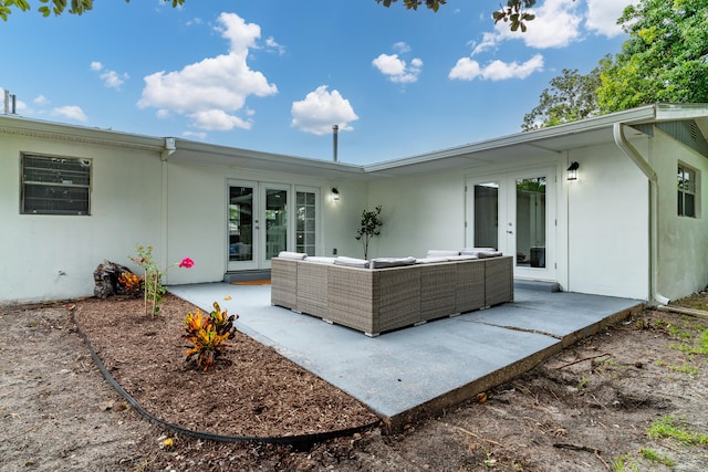 rear view of property with french doors, an outdoor hangout area, and a patio