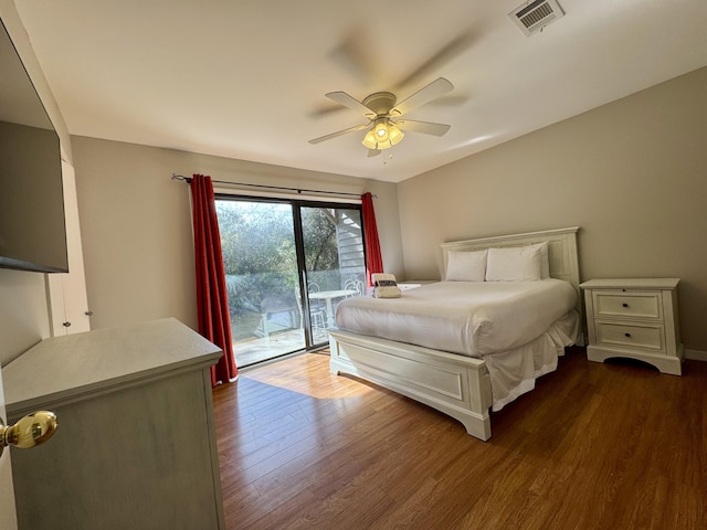 unfurnished bedroom featuring access to exterior, ceiling fan, and dark wood-type flooring