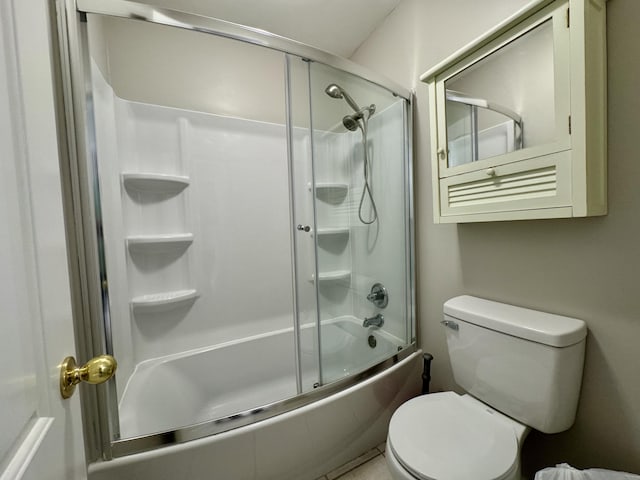 bathroom featuring toilet and bath / shower combo with glass door