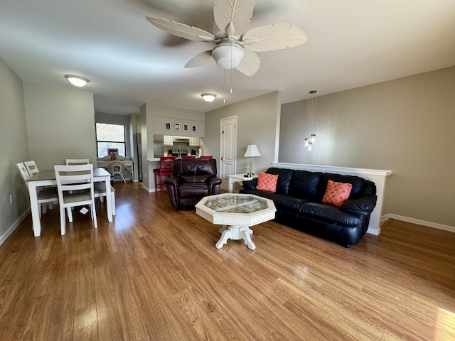 living room featuring wood-type flooring and ceiling fan