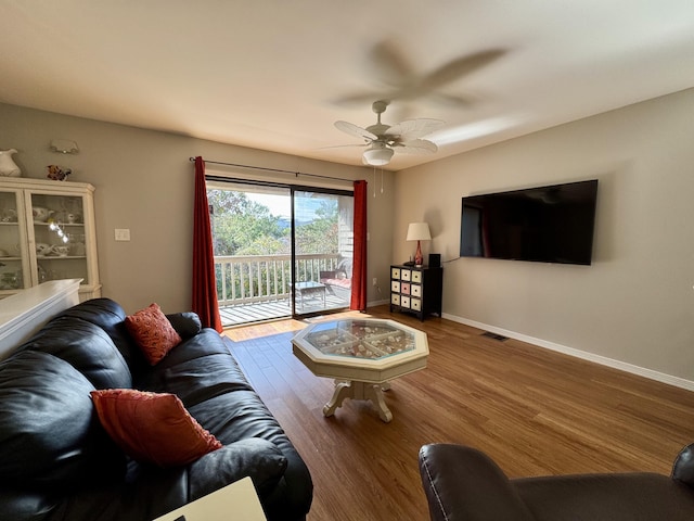 living room with hardwood / wood-style floors and ceiling fan