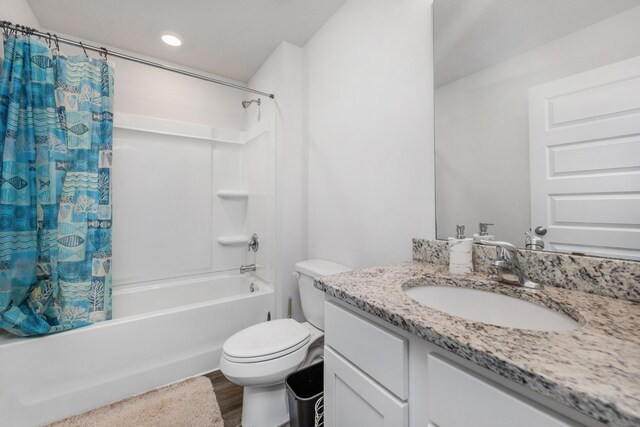 full bathroom with vanity, toilet, hardwood / wood-style flooring, and shower / bathtub combination with curtain