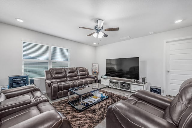 living room featuring ceiling fan and hardwood / wood-style flooring