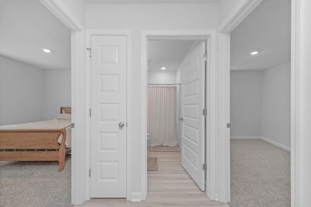 corridor featuring light colored carpet, recessed lighting, and baseboards