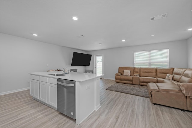 kitchen with visible vents, a sink, light wood-type flooring, open floor plan, and stainless steel dishwasher