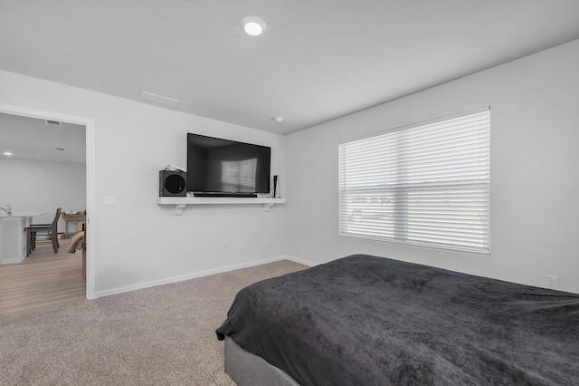 carpeted bedroom with baseboards