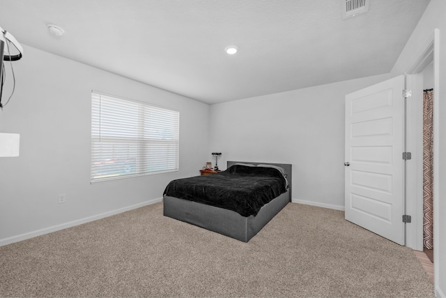 bedroom featuring baseboards, visible vents, and carpet
