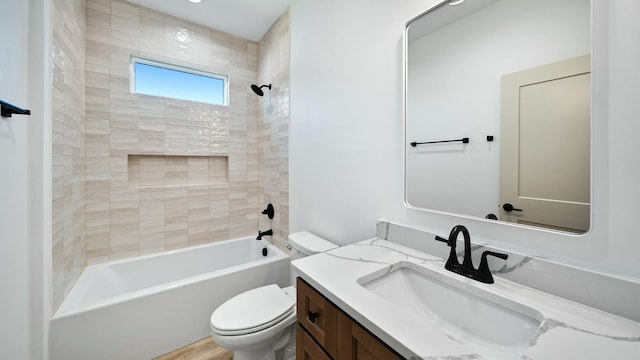 full bathroom with hardwood / wood-style floors, tiled shower / bath combo, toilet, and vanity