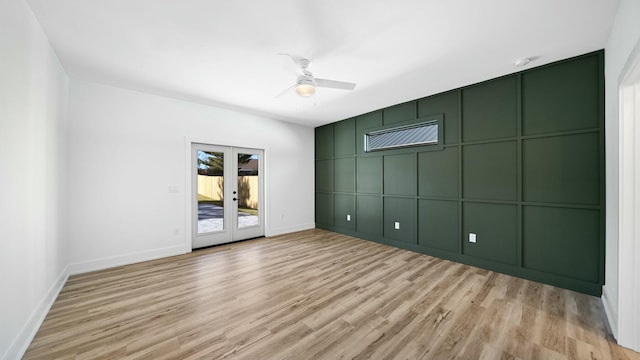 unfurnished room featuring ceiling fan, light hardwood / wood-style flooring, and french doors