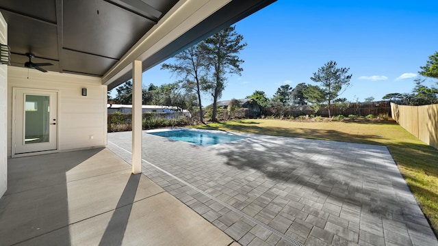 view of swimming pool with a yard, a patio, and ceiling fan