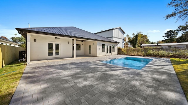 view of swimming pool with french doors, ceiling fan, and a patio area