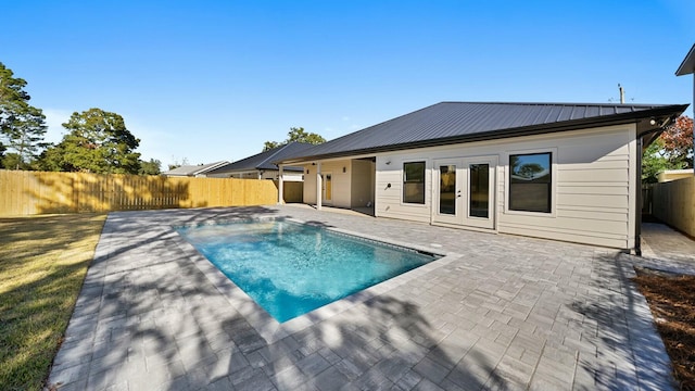 view of pool with french doors and a patio area