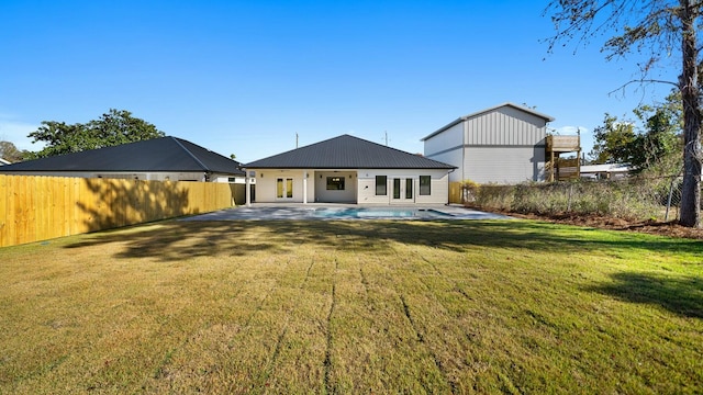 back of house featuring a patio and a lawn