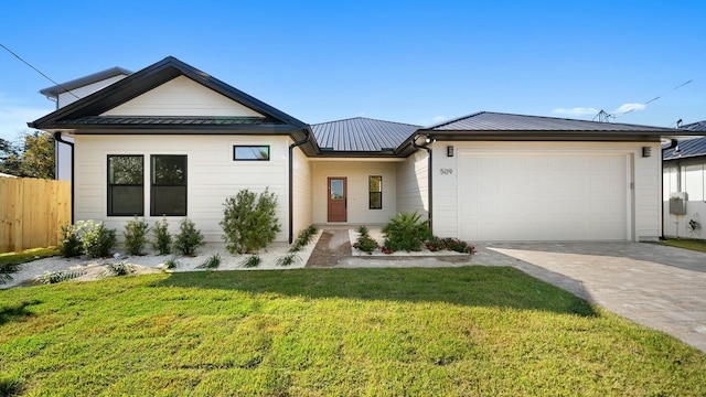 view of front of property with a front lawn and a garage