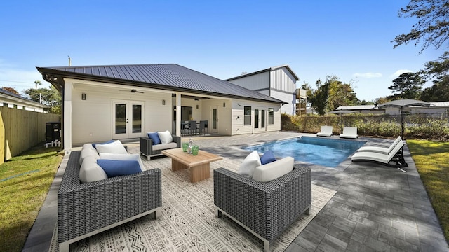 view of pool with ceiling fan, an outdoor living space, a patio, and french doors