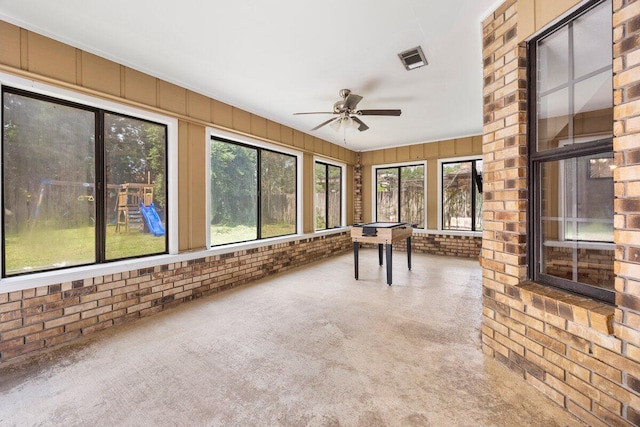 2205 Calle De Marbella, Navarre, FL 32566 - unfurnished sunroom with carpet, a ceiling fan, visible vents, and brick wall