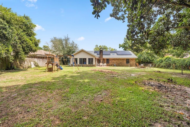 2205 Calle De Marbella, Navarre, FL 32566 - view of yard featuring a patio area, a playground, and a fenced backyard