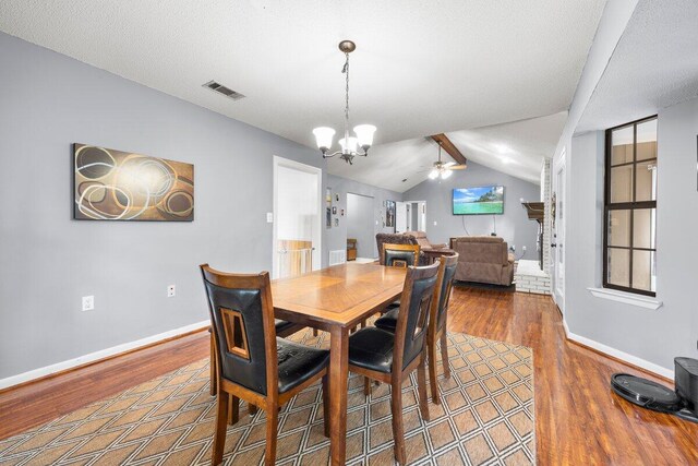 2205 Calle De Marbella, Navarre, FL 32566 - dining room featuring ceiling fan with notable chandelier, vaulted ceiling, wood finished floors, and visible vents