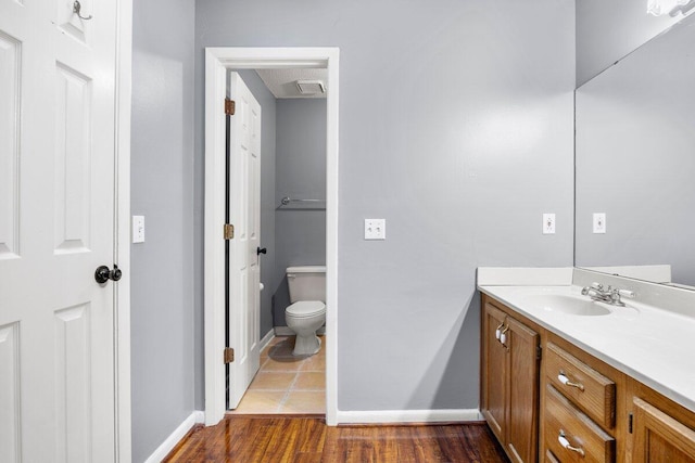 2205 Calle De Marbella, Navarre, FL 32566 - bathroom with toilet, vanity, baseboards, and wood finished floors
