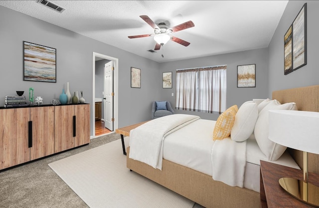 2205 Calle De Marbella, Navarre, FL 32566 - bedroom featuring carpet flooring, visible vents, ensuite bathroom, and a textured ceiling