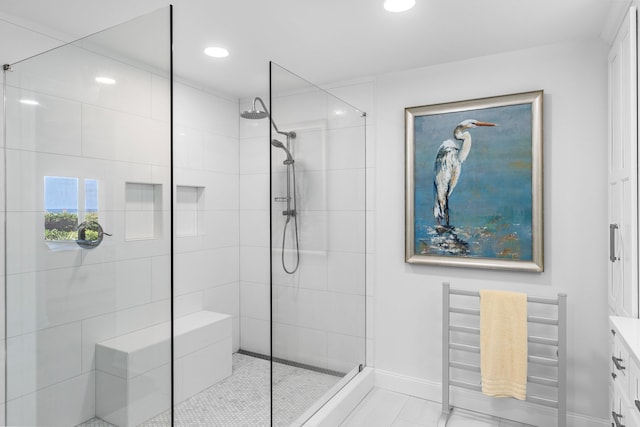 bathroom featuring walk in shower and vanity