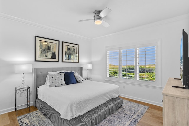 bedroom with ceiling fan, crown molding, and wood-type flooring