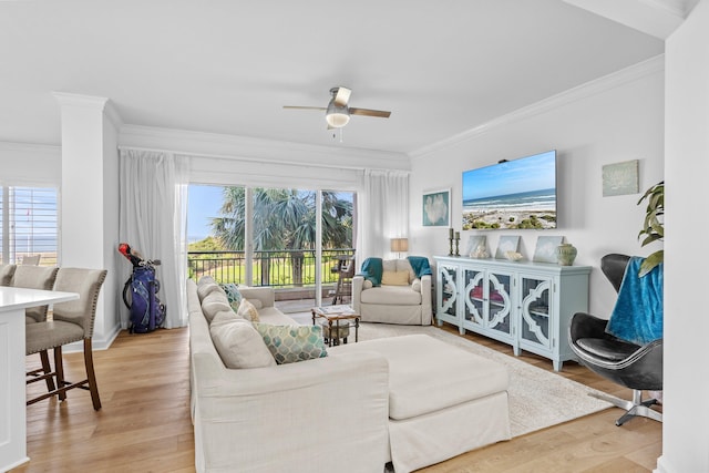 living room with ceiling fan, ornamental molding, and light hardwood / wood-style floors