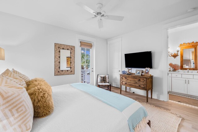 bedroom featuring light wood-type flooring, access to exterior, sink, ensuite bathroom, and ceiling fan