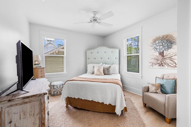 bedroom with light wood-type flooring and ceiling fan