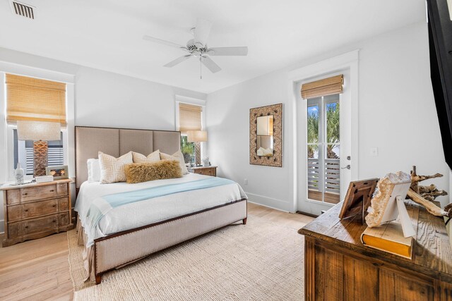 bedroom featuring light hardwood / wood-style floors, ceiling fan, and access to exterior