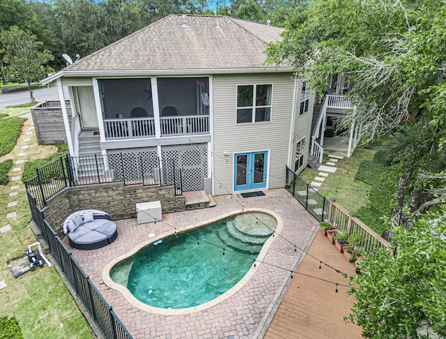 back of house featuring a fenced in pool, a patio, and a sunroom