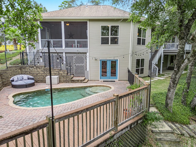 view of swimming pool featuring a patio and a sunroom