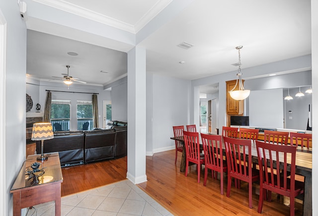 dining room featuring ornamental molding, light hardwood / wood-style flooring, and ceiling fan