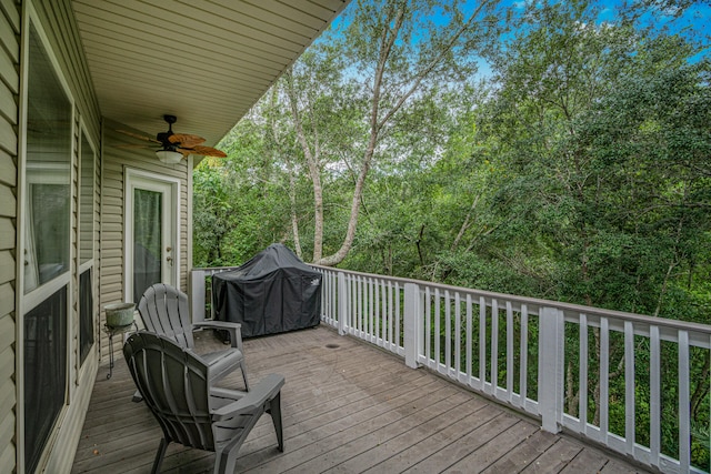 deck featuring ceiling fan and a grill