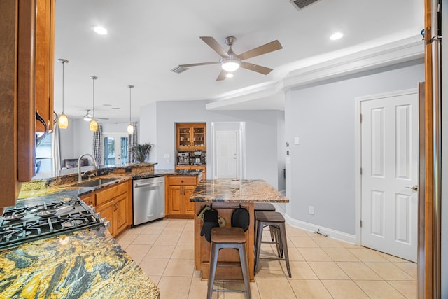 kitchen with a breakfast bar area, decorative light fixtures, stainless steel appliances, ceiling fan, and dark stone counters