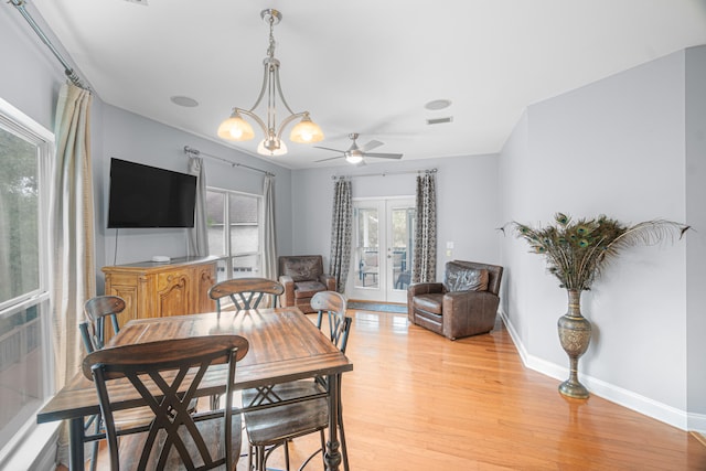 dining space with light wood-type flooring, ceiling fan, and french doors