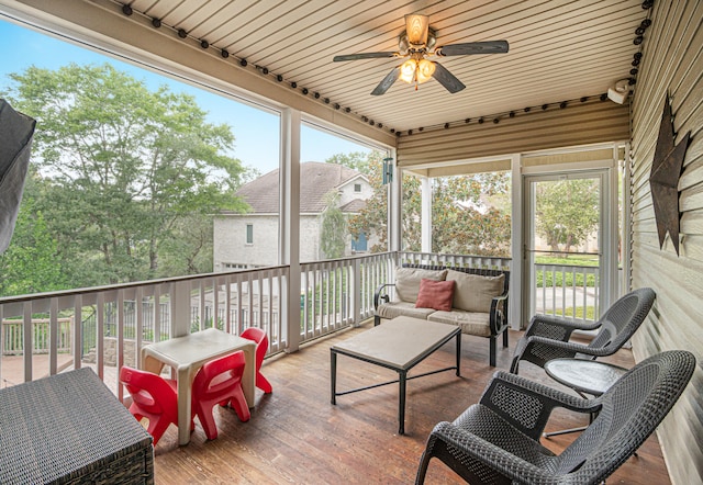 sunroom featuring wooden ceiling, a healthy amount of sunlight, and ceiling fan