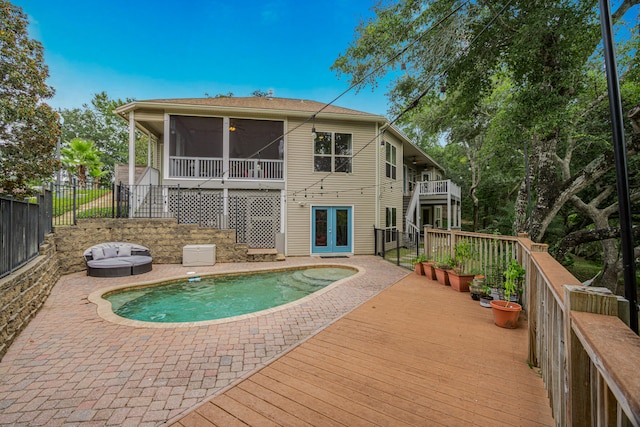 view of swimming pool with a sunroom and a patio