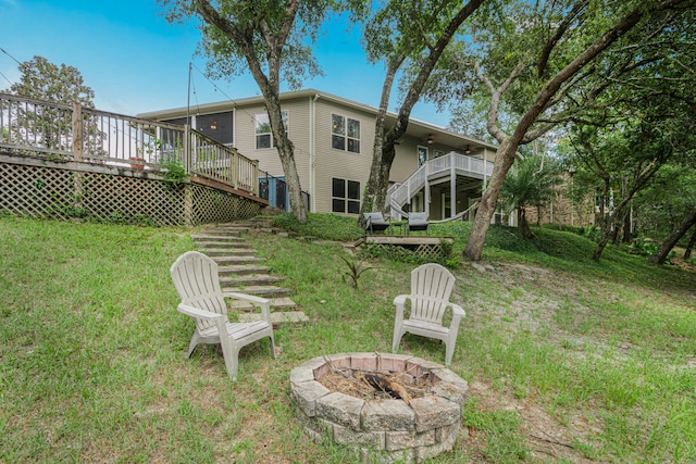 view of yard with a fire pit and a deck